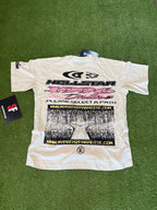 White t-shirt with graphics and text on a green surface